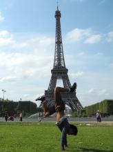 Kevin Velasco doing handstand in front of Eiffel Tower