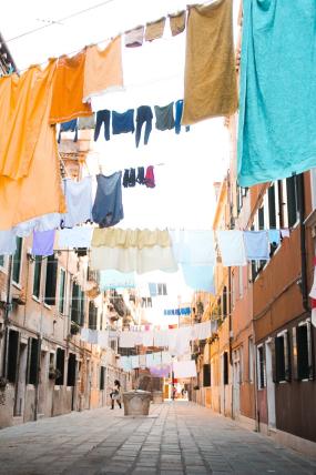 Narrow street with colorful linen hanging above