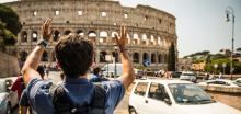 man in front of Roman Coliseum