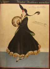 Vintage Vogue Photo of a Woman's Winter Fashion - Dressed in all black, skirt and jacket, with leopard printed gloves, collar and skirt hem, and a black hat. 