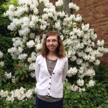 Christina Sztajnkrycer in front of flowering bush