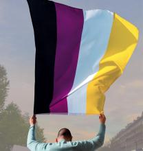 Person holding non-binary flag