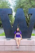 Student in front of purple W