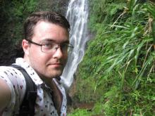 Selfie of Mathew in front of waterfall