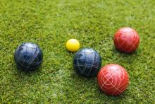 Bocce balls on a grass lawn.