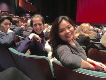 two students and professor in seats at opera 