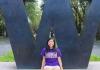 Student in front of purple W