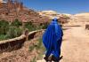 Person walking across Morocco in a bright blue Muslim dress